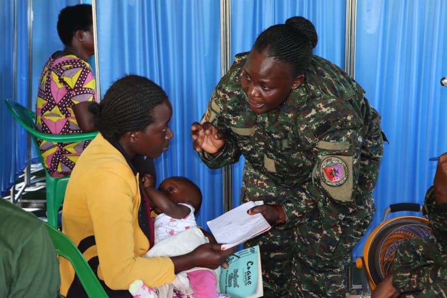 SSgt Namakoye Edith guiding a mother about medicine.