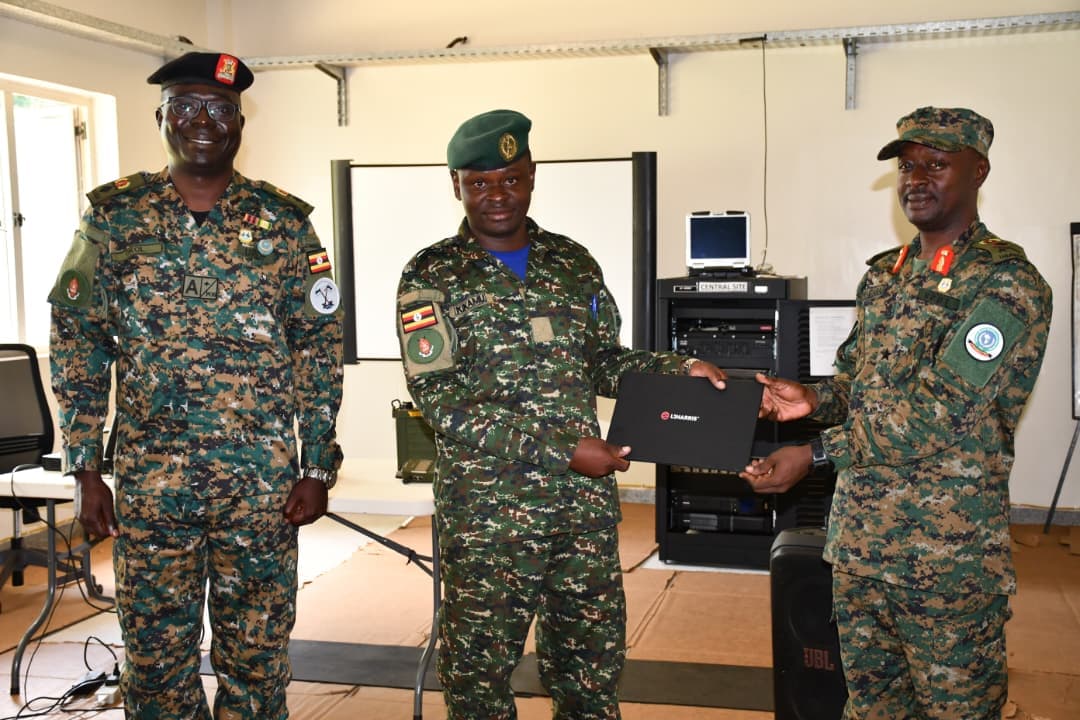 Brig Gen Ernest Nuwagaba awarding a certificate to one of the graduands.