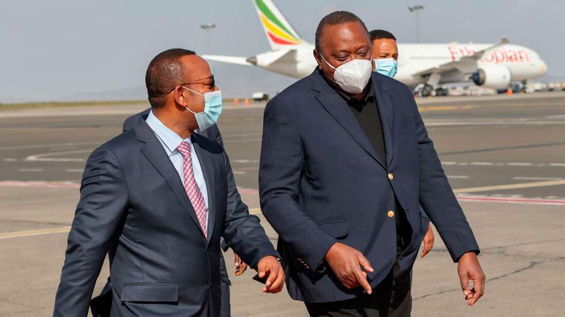 Ethiopian Prime Minister Abiy Ahmed and Kenya's President Uhuru Kenyatta at Bole International Airport in Addis Ababa  