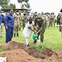 Gen Muhoozi Kainerugaba and his youngest daughter watering a tree after planting